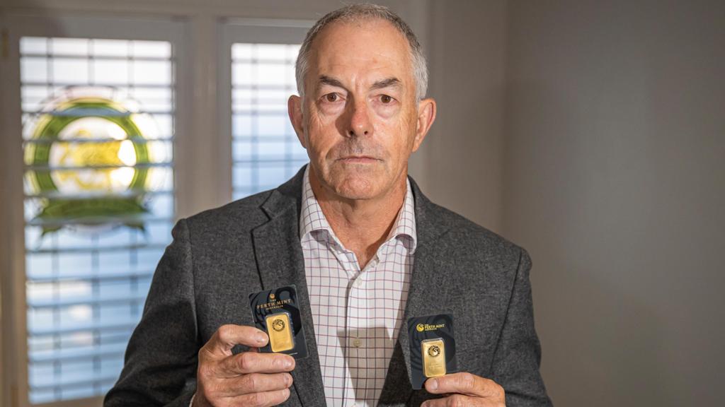 珀斯铸币厂首席运营官Dion Paunich手持真金条（左）和假金条（右）。图源:西澳人报